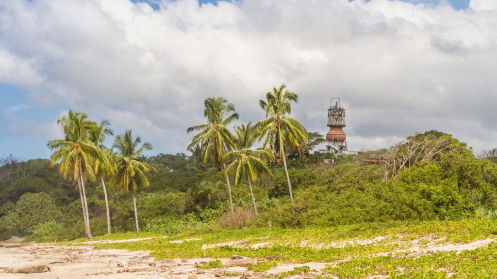 Palm trees and a lighthouse at Nosara Beach, epitomizing the serene beauty of the best beaches in Costa Rica