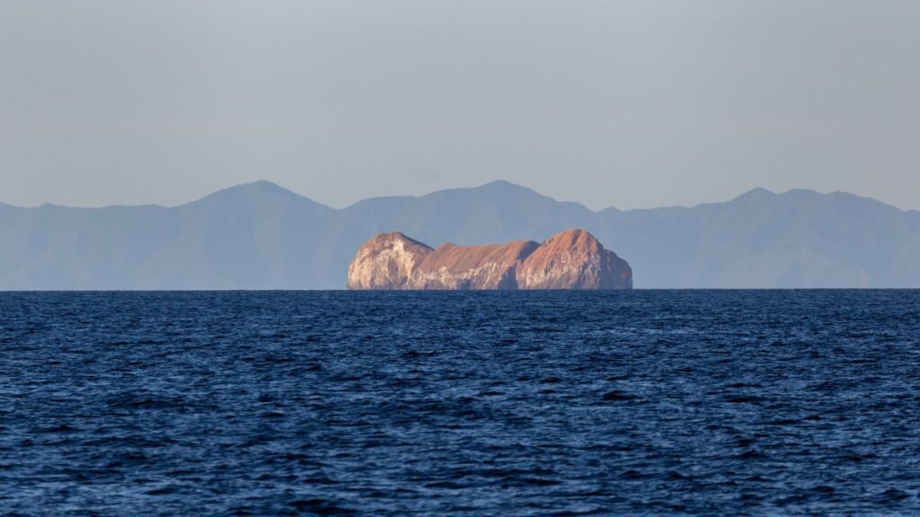 Isolated island seen from one of the best beaches in Costa Rica, highlighting the country's diverse coastal beauty