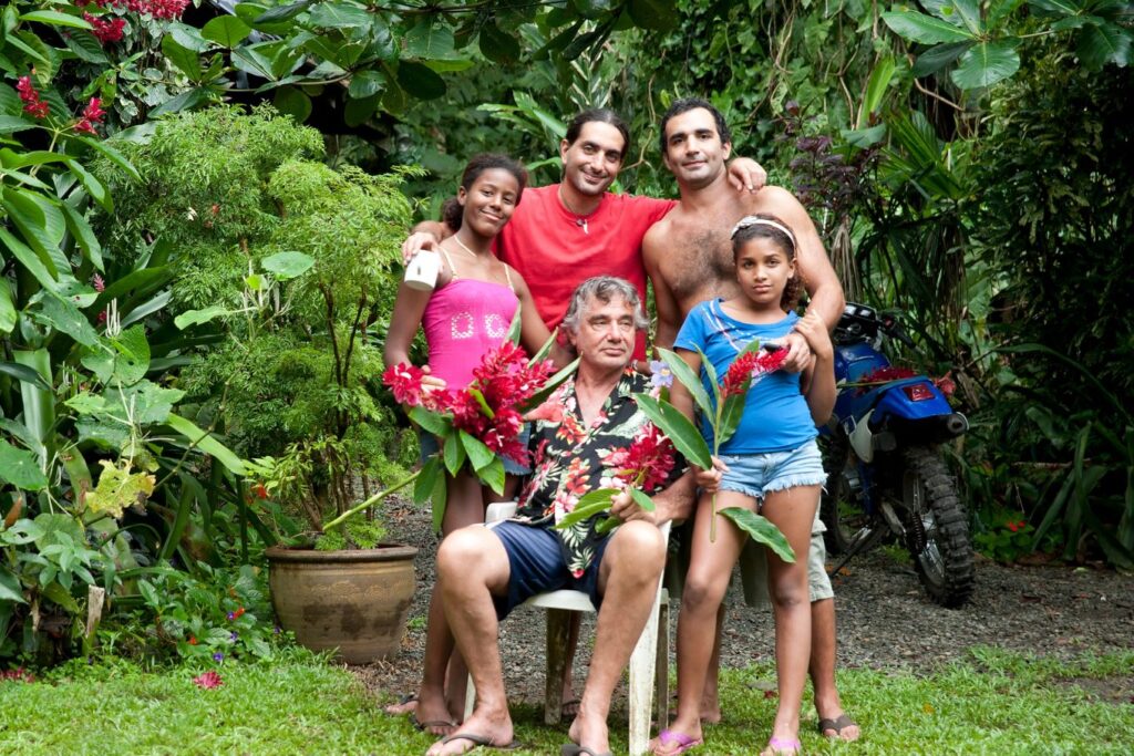 Expat Living a family enjoying their life in a lush tropical garden, representing the experiences of expats worldwide