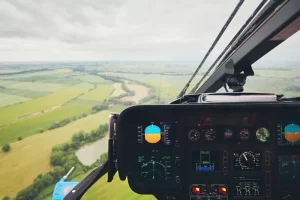 Emergency medical assistance view from helicopter cockpit over lush terrain