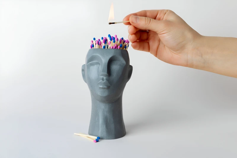 Concept of memory and thermal stress with matchsticks in head shape 